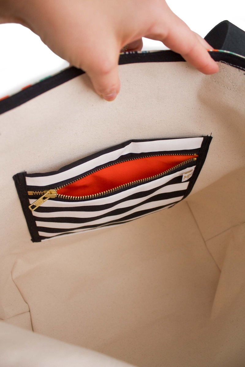 Inside view of the Golden Meadow tote showing the leakproof zipper pocket and canvas lining.