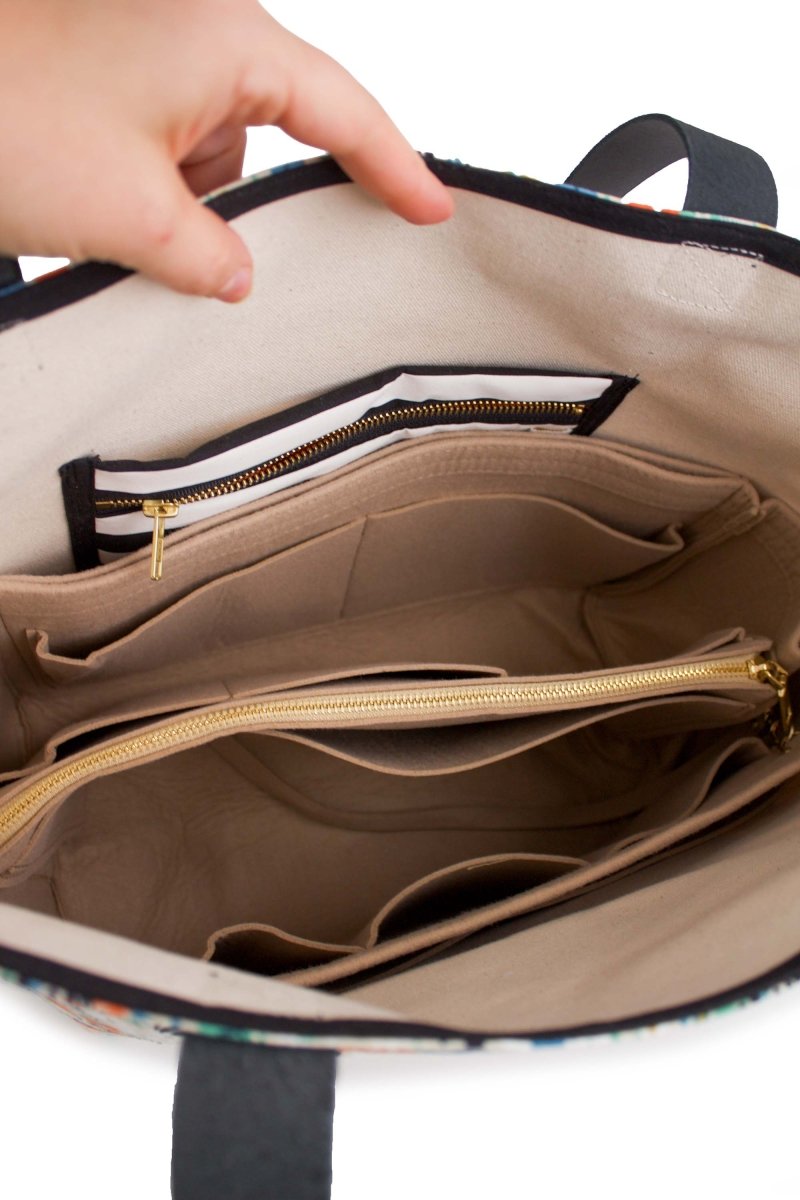 Interior of the Golden Meadow tote with the XL organizer insert packed with zipper pouches and accessories.